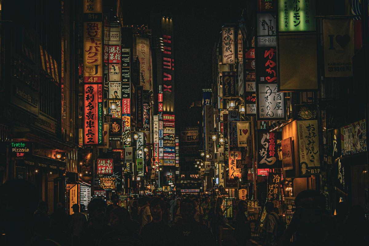 Neon signs filling a crowded Kabukicho alley at night
