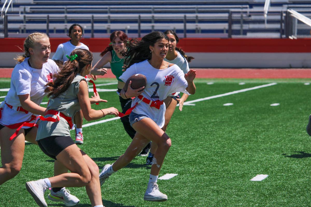 Flag football player breaking through defense